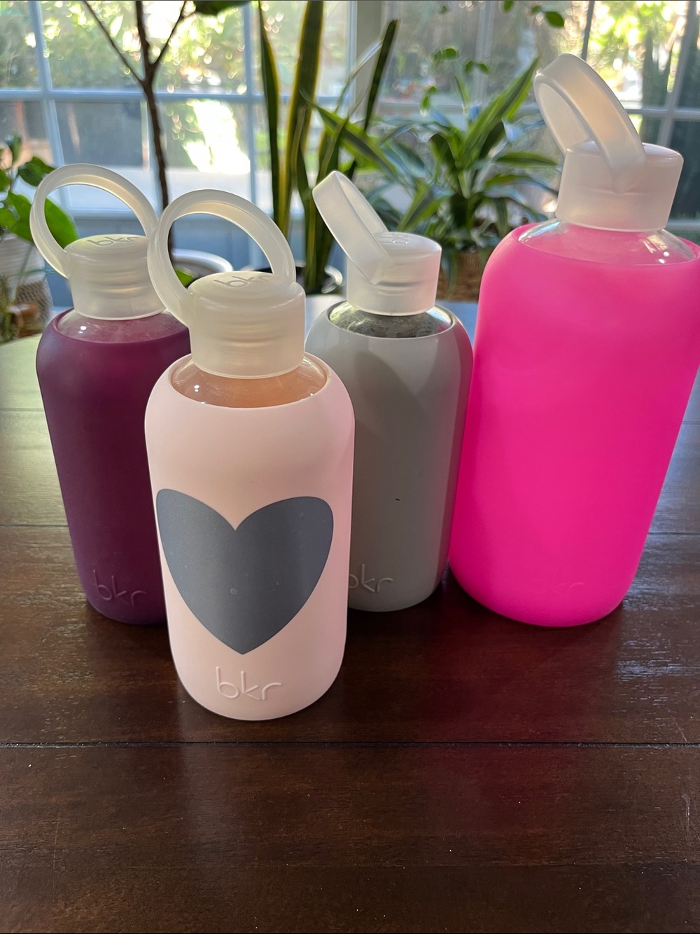 bkr Four-Pack Glass Water Bottles in Light Pink, Hot Pink, Plum & Gray